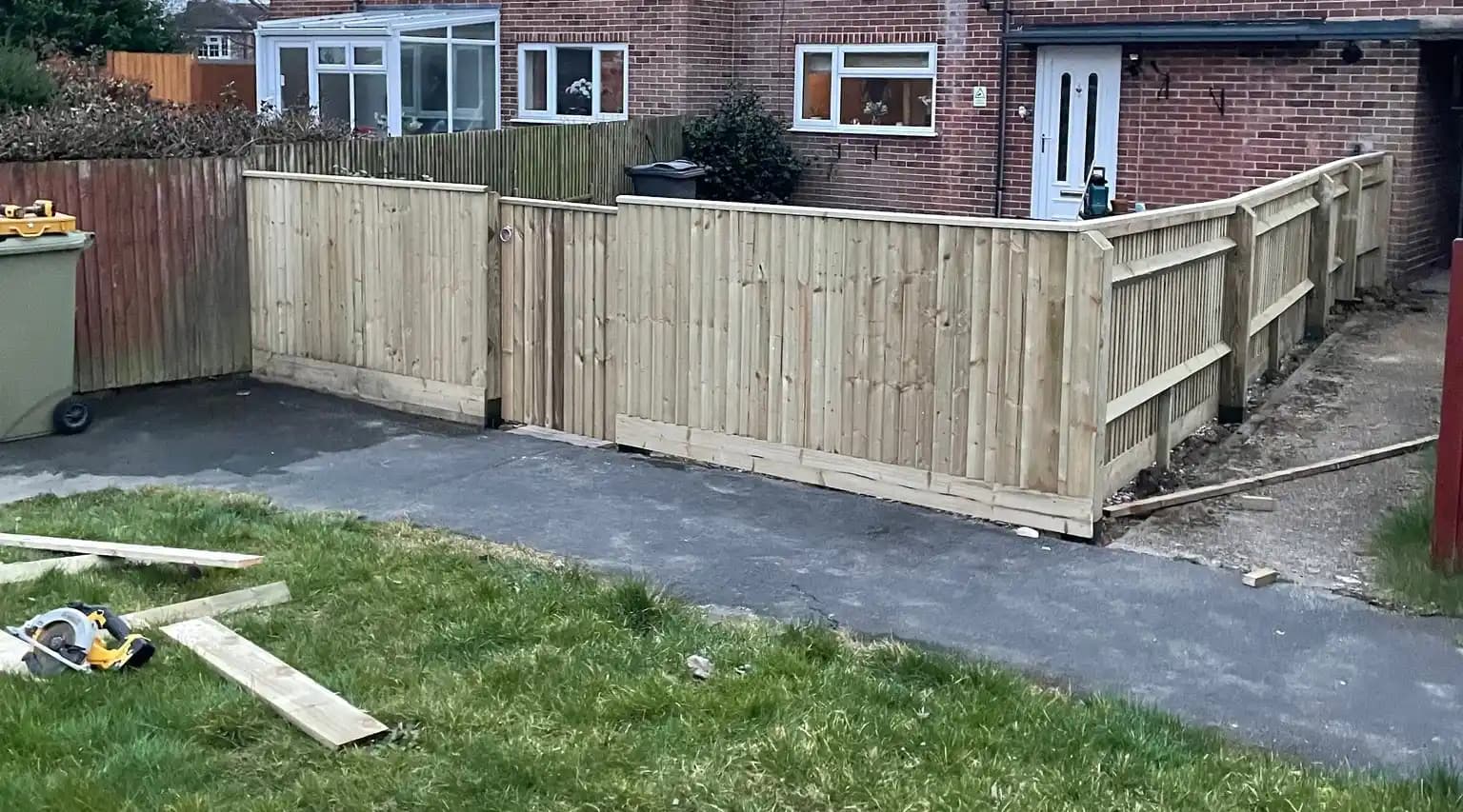 Fresh closeboard front garden fencing with matching gate and side panels installed for a house boundary.